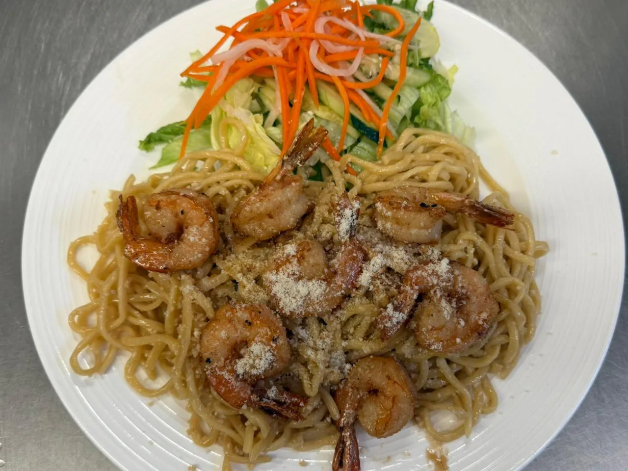 Garlic Noodle Flavorful noodles with shrimp and garlic, served with salad at An Chi, a Vietnamese restaurant in San Francisco