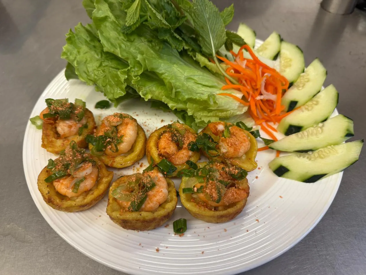 Mini Pancake Small pancakes topped with shrimp, herbs, and veggies at An Chi, a Vietnamese restaurant in San Francisco